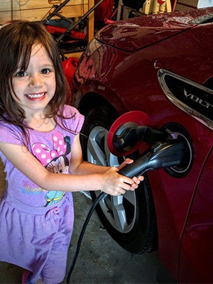 Child plugging in evse to charge an electric car