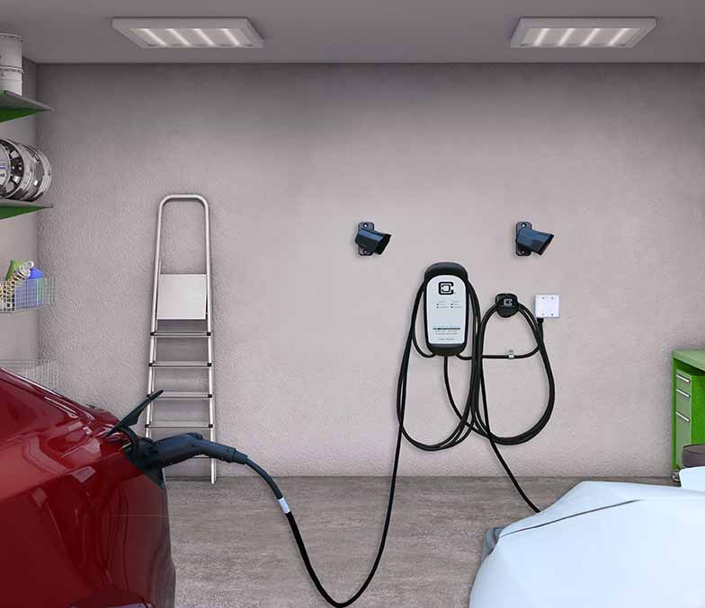 Dual EV charging station charging Tesla and Leaf in garage