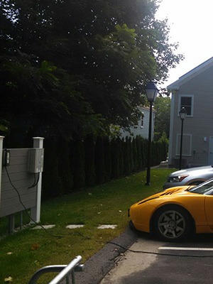 Yellow Tesla Roadster EV charging at Nonatum Resort Kennebunk ME