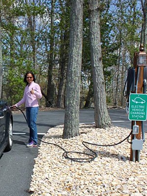 Plugging a Tesla Model S into an EV charging station at the Iris Inn in VA