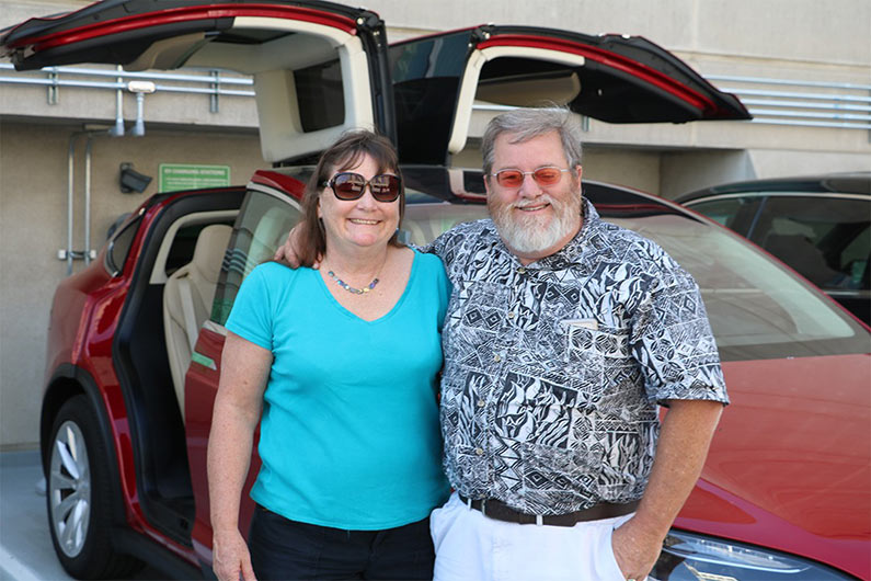 Guy Hall and wife with Tesla Model X
